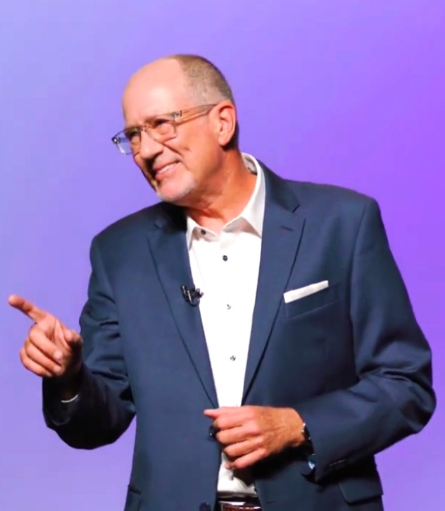 Don Phin speaking on stage